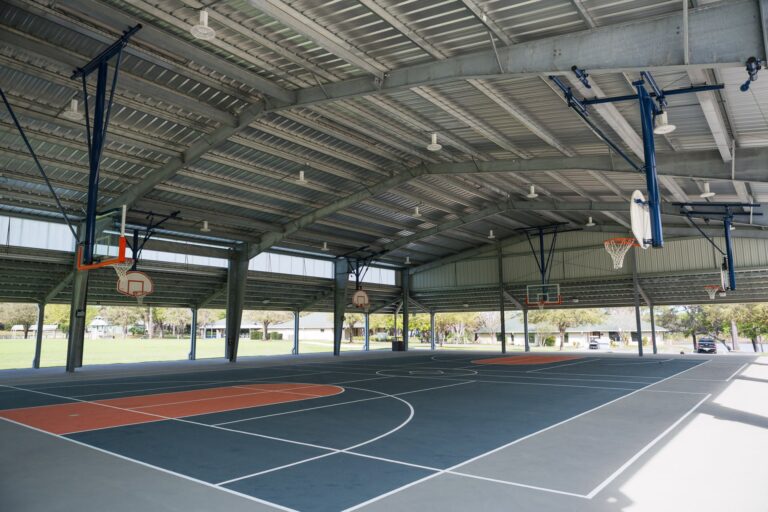 Covered outdoor basketball court pavilion at Young Life camp facility with steel structure