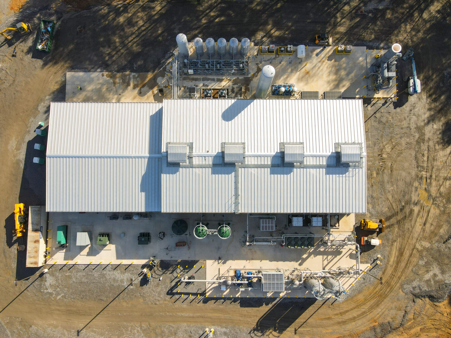 Aerial view of industrial facility with tanks and equipment under construction