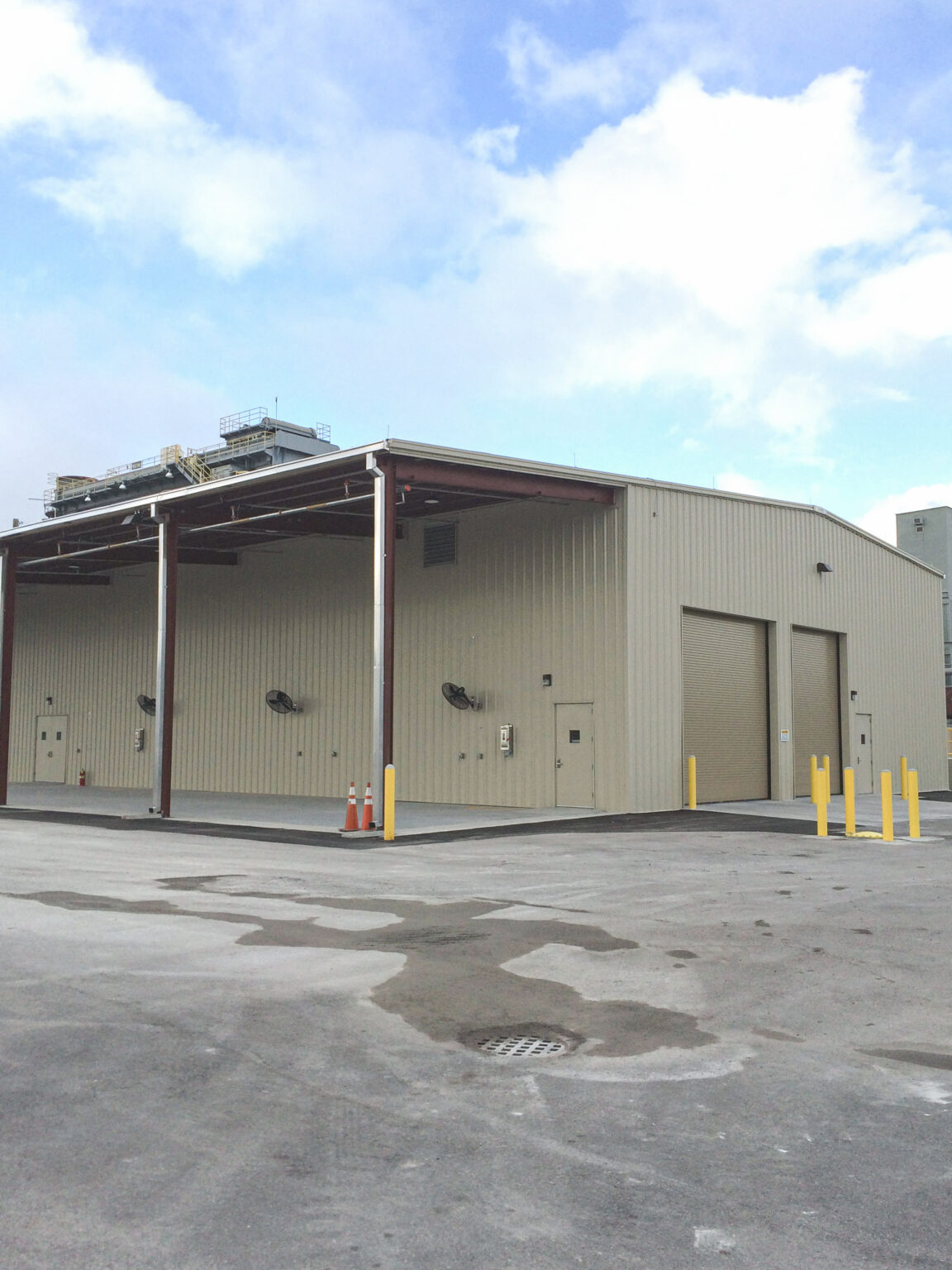 Metal industrial building exterior with large bay doors