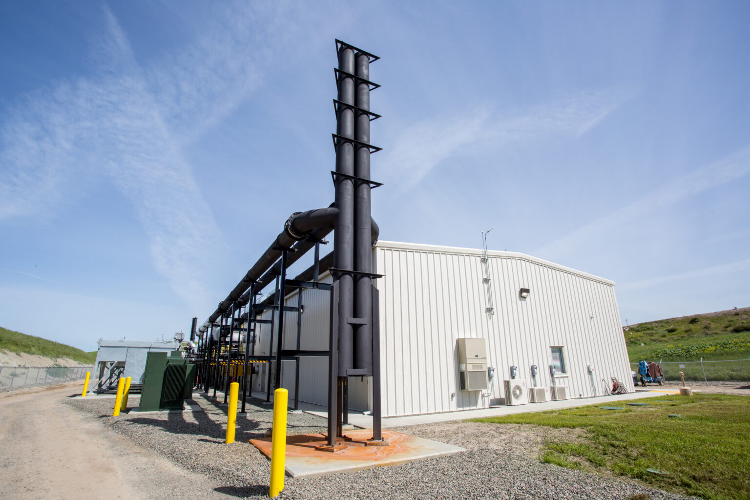 Industrial facility with structural steel framework and piping system