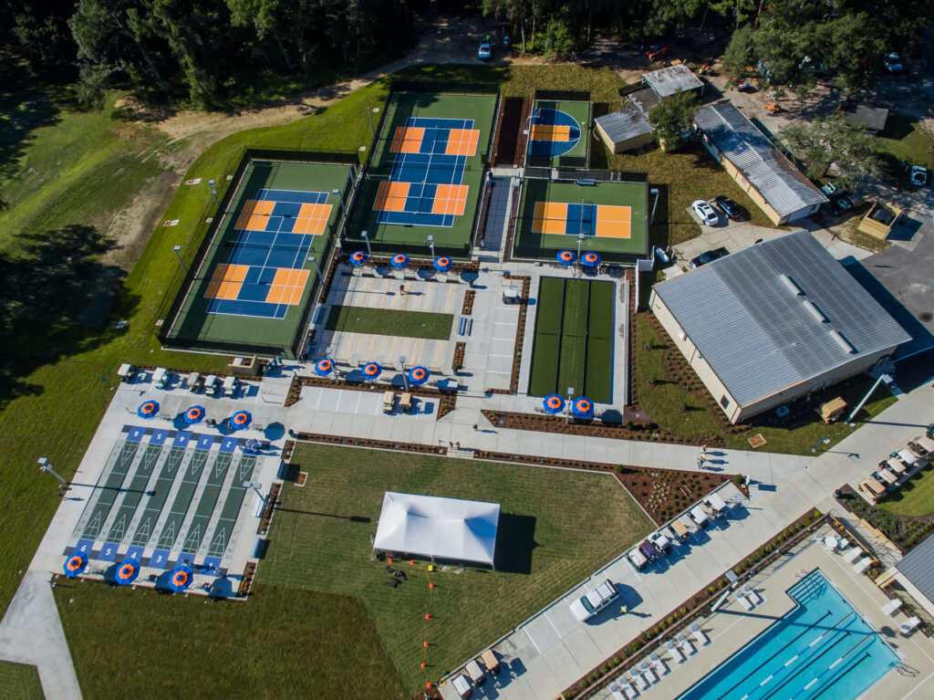 Aerial view of Rolling Greens Ocala Florida showing renovated tennis courts pickleball courts and recreation amenities